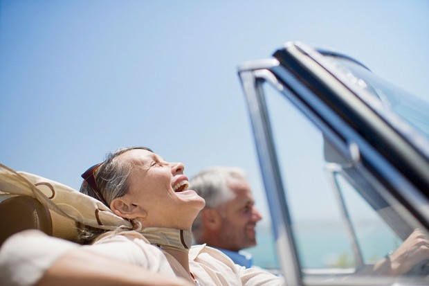 © Getty Images Un couple de personnes âgées souriant dans une voiture décapotable © Getty Images