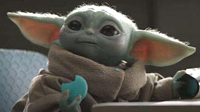 Vous pourrez bientôt ajouter un bébé Yoda Tamagotchi à votre collection 7 Bébé Yoda grignotant un macaron dans le Mandalorien.